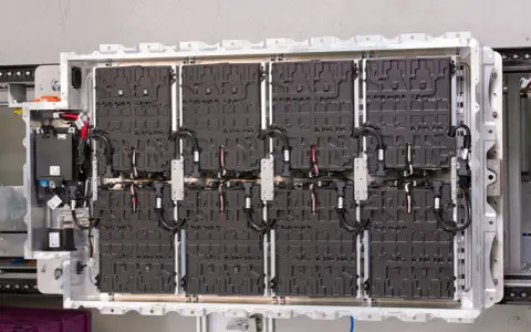 Wielki magazyn energii z akumulatorów samochodowych, gotowy do zasilenia elektrycznego pojazdu.